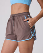 Brown athletic shorts with blue accents on a gray background